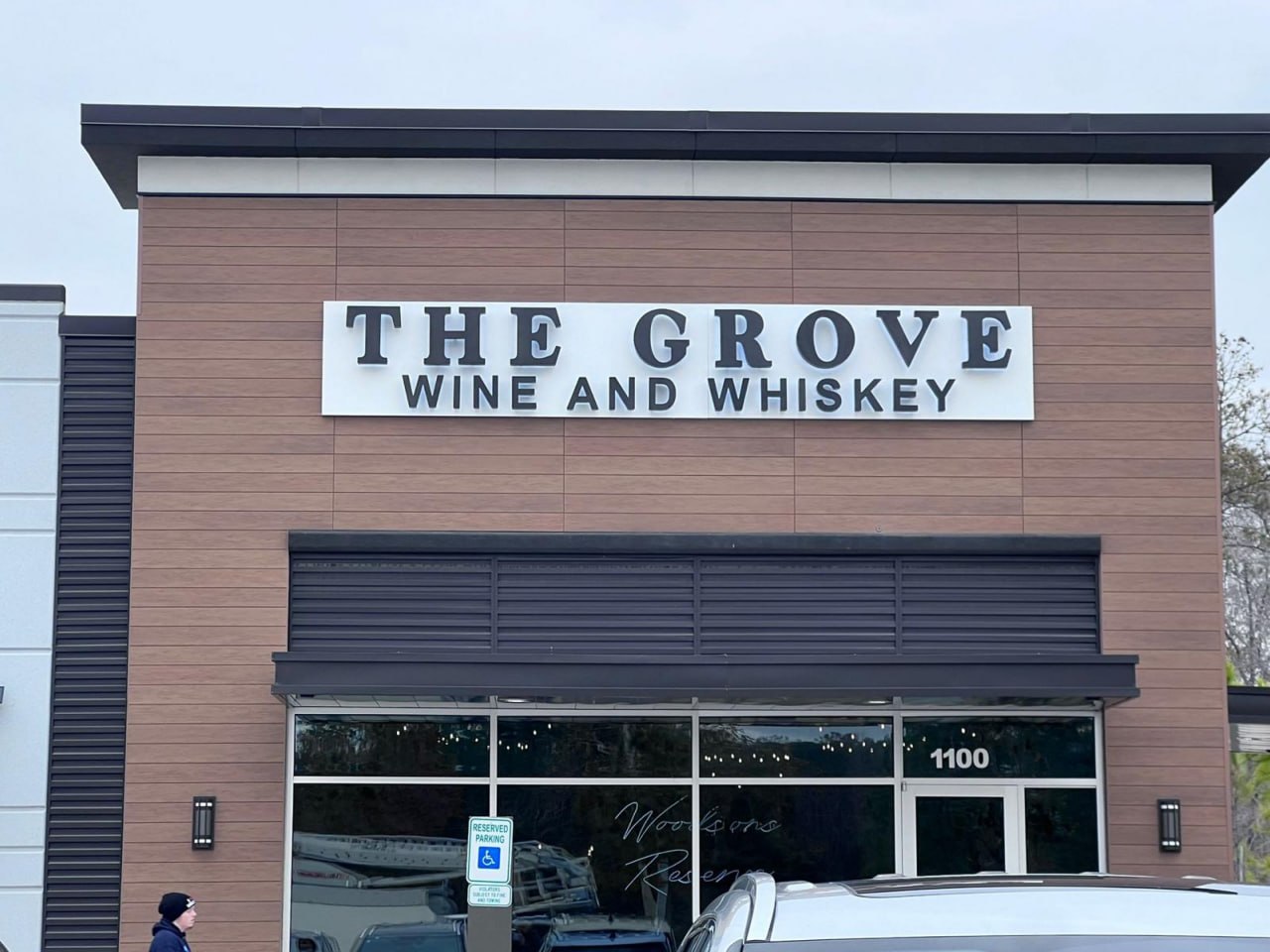The Grove Wine and Whiskey dimensional letters on a backer panel above the storefront