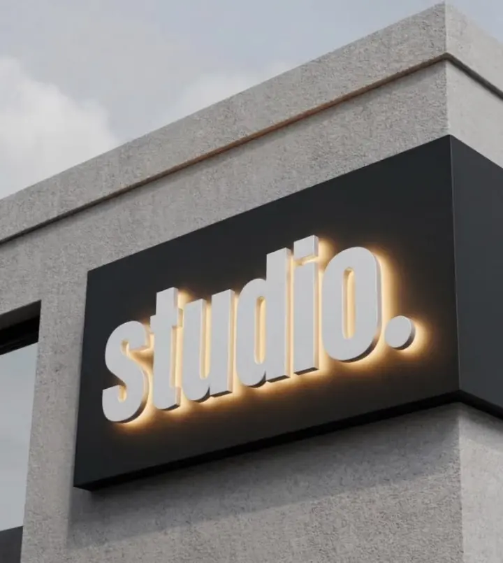 Studio front and halo-lit channel letters on a dark corner backer panel