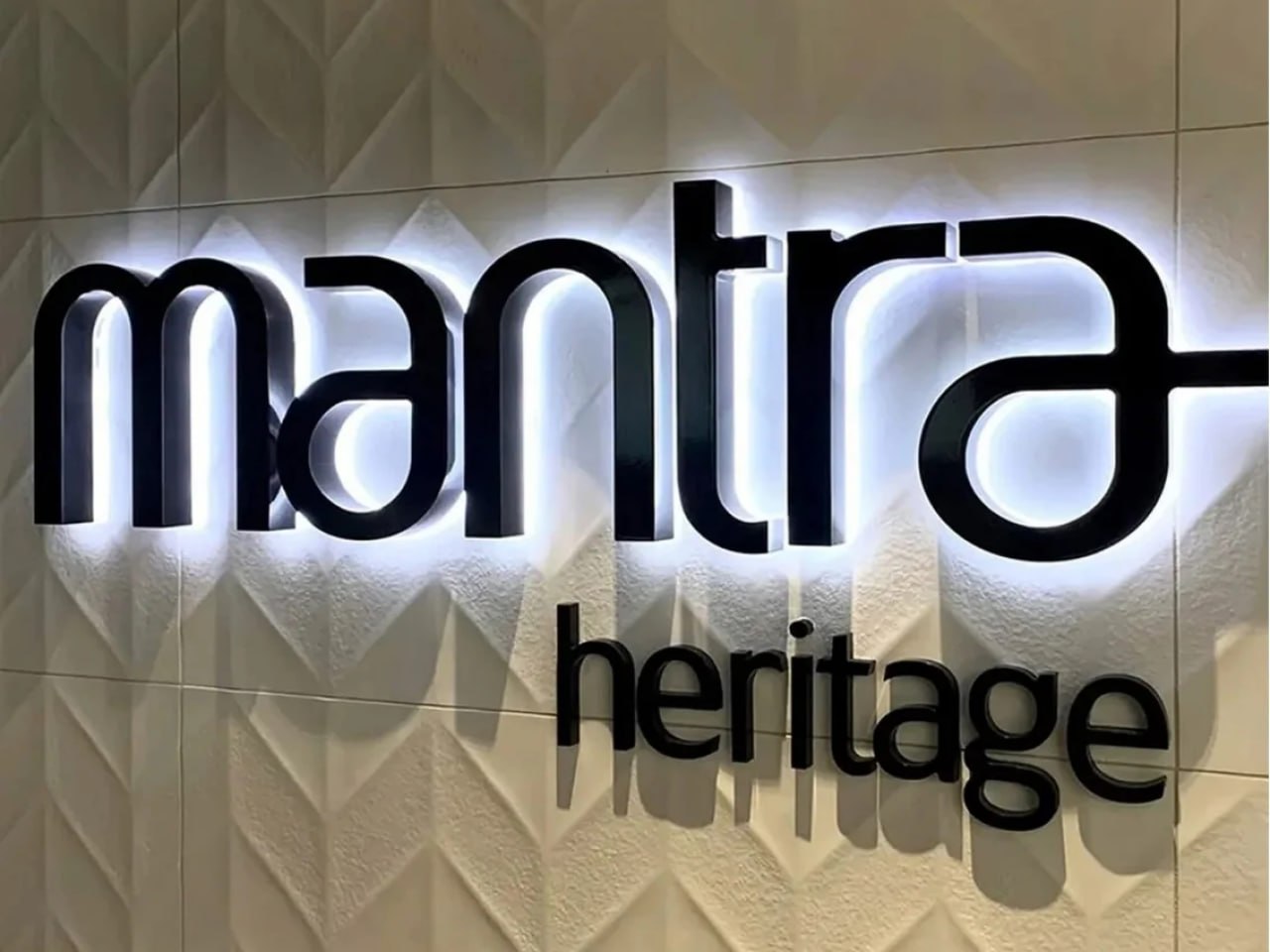 Mantra Heritage halo-lit reverse channel letters on a textured tile wall